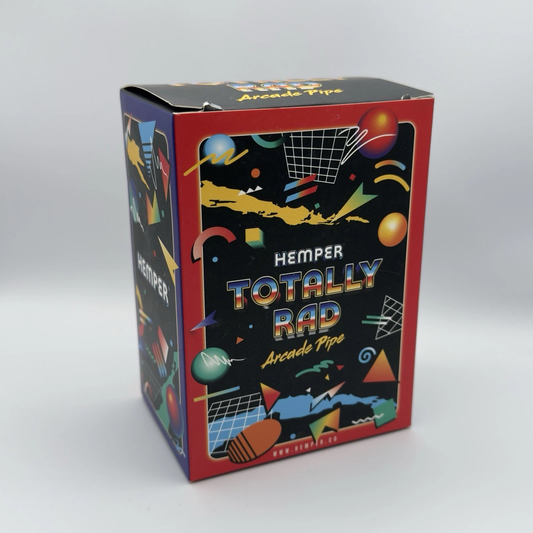 A product box for 'Hemper Totally Rad Arcade Pipe' featuring a colorful 90s retro design with geometric shapes, basketball nets, and a black background on a light gray studio backdrop.