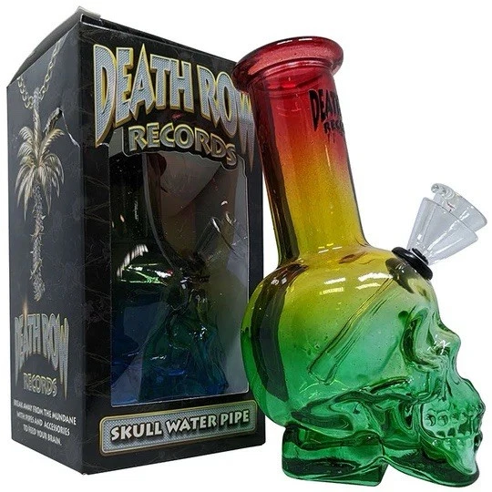 Glass skull water pipe with rasta colors next to a 'Death Row Records' box.