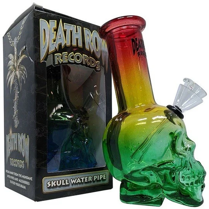 Glass skull water pipe with rasta colors next to a 'Death Row Records' box.
