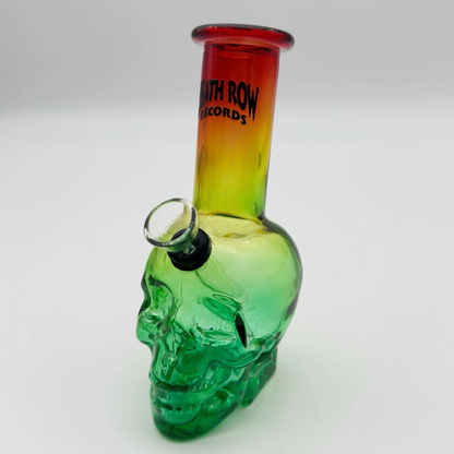 Glass skull-shaped pipe with a red and yellow gradient top on a white background