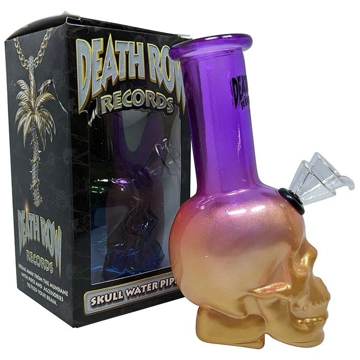 Glass skull water pipe with purple top and gold base next to a 'Death Row Records' box.