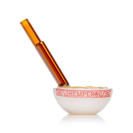 White bowl with red text and amber-colored pestle on a white background