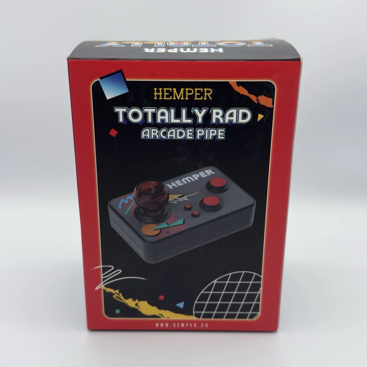 The retail packaging box for the Hemper Totally Rad Arcade Pipe, featuring a red border and a black center panel with an illustration of the retro arcade joystick controller.
